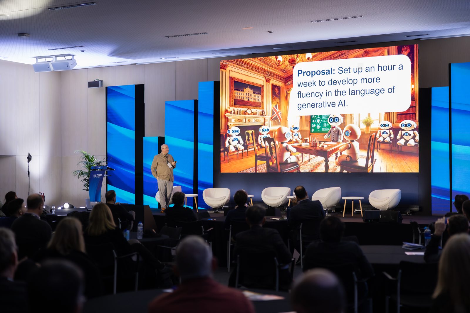 Dominik Lukeš presenting to a seated audience at ISE 2025, in front of a large screen showing a slide titled Proposal